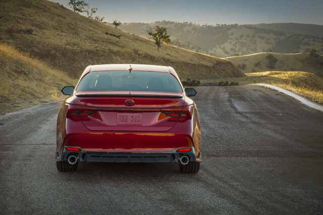 2020 Toyota Avalon TRD Rear View on Winding Road Showing Quad Exhaust and Diffuser