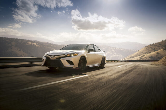 2020 Toyota Camry TRD Front Three-Quarter Action Shot on Mountain Highway with Sun Flare