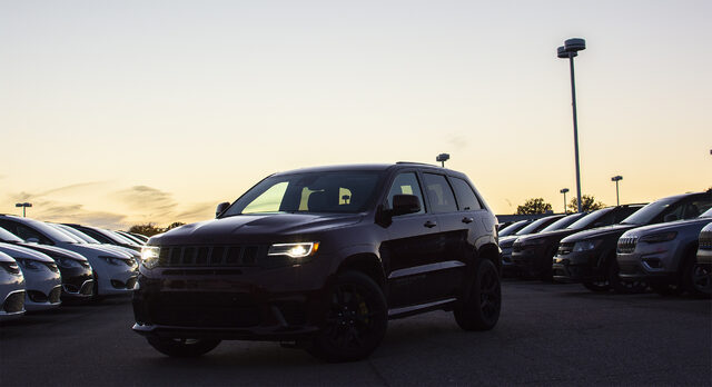 2018 Jeep Grand Cherokee SRT Trackhawk at dusk with headlights on