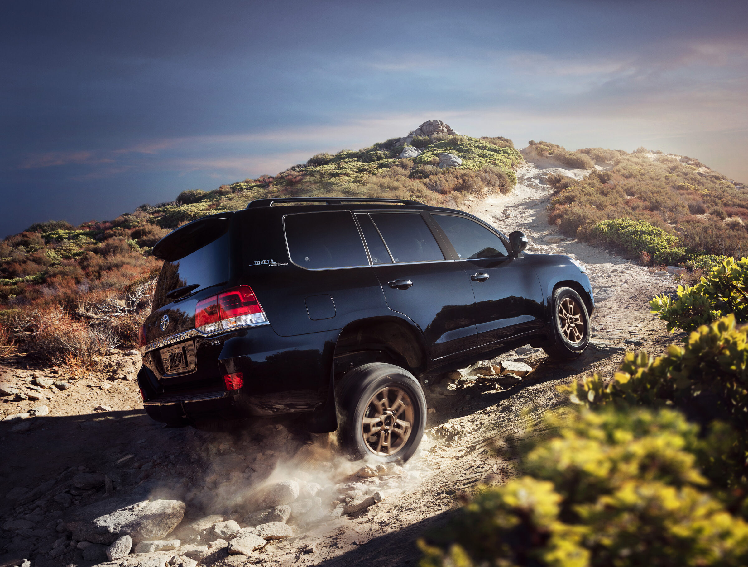 2020 Toyota Land Cruiser Heritage Edition Exterior Rear Three-Quarter Action Shot on Rocky Hill