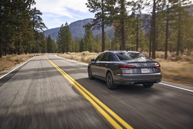 2020 Volkswagen Passat rear view driving on forested mountain road