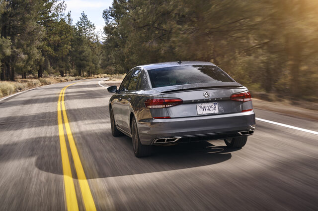 2020 Volkswagen Passat rear action shot on pine-lined road