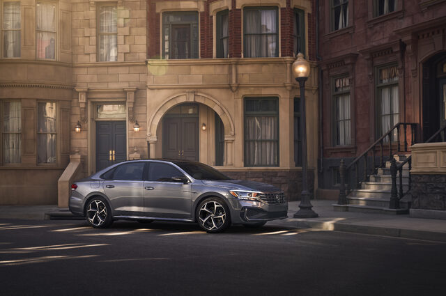 2020 Volkswagen Passat side profile on city street with brownstone buildings
