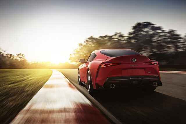 2020 Toyota GR Supra red rear three-quarter view on track at sunset
