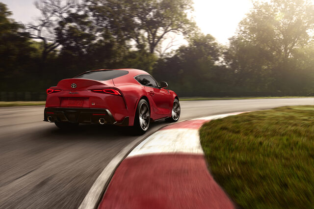 2020 Toyota GR Supra red rear three-quarter cornering on race track