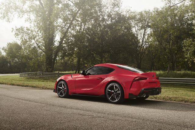2020 Toyota GR Supra red rear three-quarter stationary view with trees