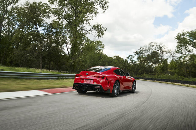 2020 Toyota GR Supra red rear three-quarter exiting corner on race track