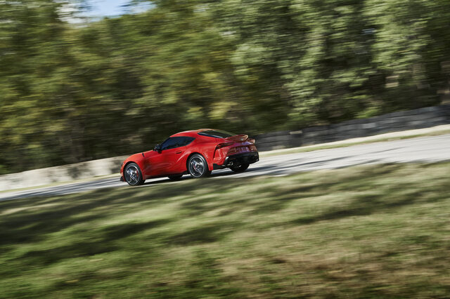 2020 Toyota GR Supra red elevated rear three-quarter action shot at speed