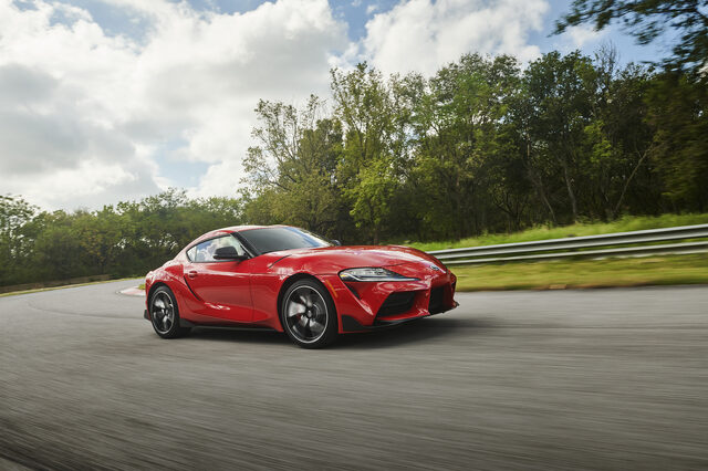 2020 Toyota GR Supra red front three-quarter moving shot on track with sky