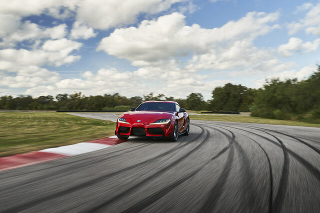 2020 Toyota GR Supra Front View Cornering on Track Under Cloudy Sky
