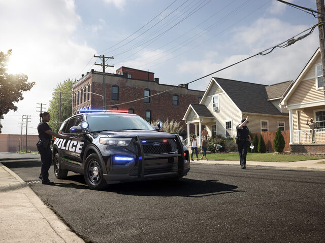 2020 Ford Police Interceptor Utility black on residential street with lights on