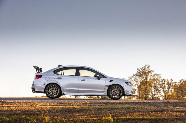2019 Subaru WRX STi S209, full side profile static on road at dusk with gold wheels