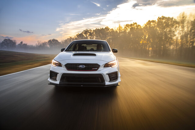 2019 Subaru WRX STi S209, direct front action shot at speed with sunrise behind