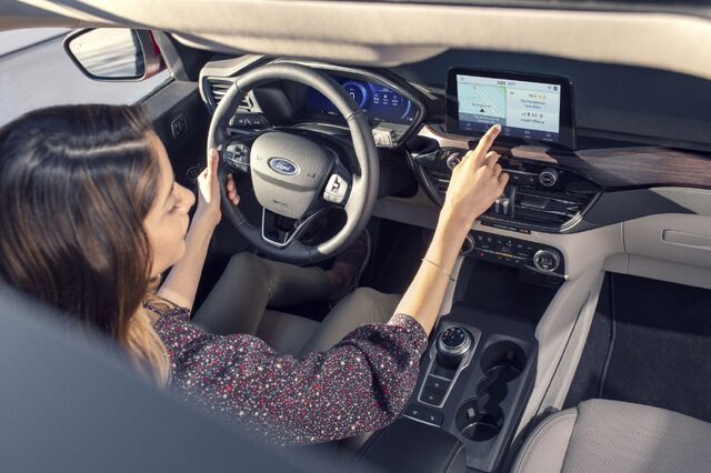 2020 Ford Escape Titanium Driver Interacting with SYNC Touchscreen