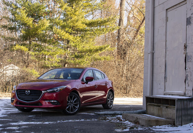 2018 Mazda3 Grand Touring Hatchback Front Three-Quarter View with Evergreen Trees