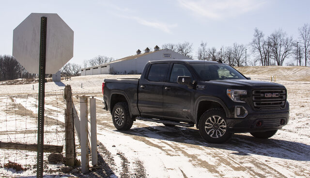 2019 GMC Sierra 1500 AT4 front three-quarter at rural intersection