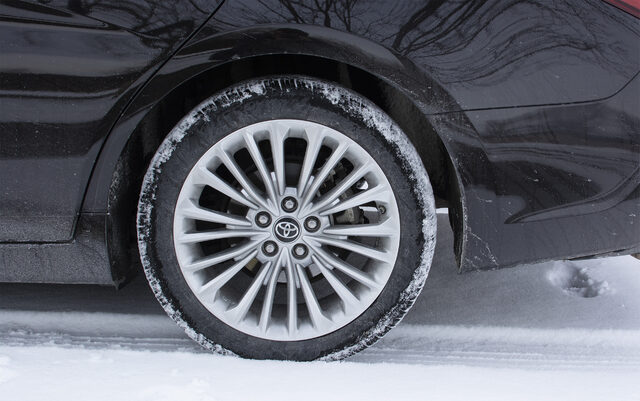 2019 Toyota Avalon Hybrid Limited alloy wheel close-up in snow
