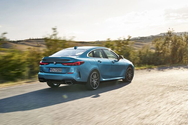 2020 BMW M235i xDrive Gran Coupe rear three-quarter driving on curved road