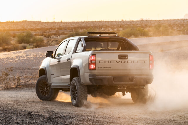 2021 Chevrolet Colorado ZR2 rear view at golden hour kicking up desert dust