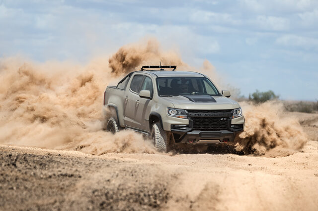 2021 Chevrolet Colorado ZR2 front three-quarter kicking up dust cloud off-road