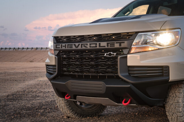 2021 Chevrolet Colorado ZR2 front grille close-up at dusk with red tow hooks