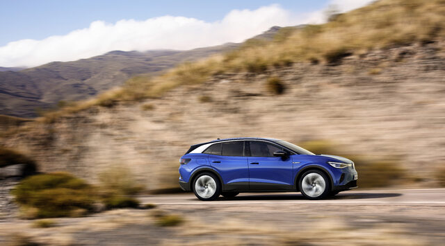 2021 Volkswagen ID.4 side profile driving through hilly terrain