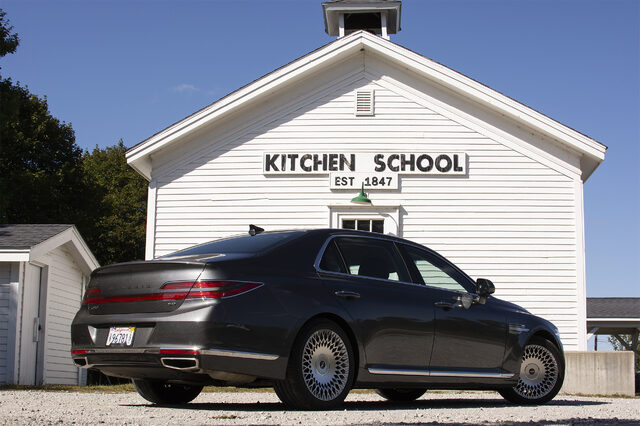 2020 Genesis G90 5.0 Ultimate rear three-quarter at historic schoolhouse