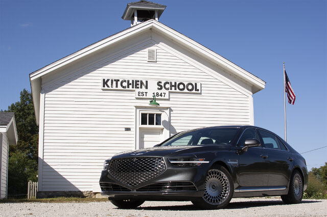2020 Genesis G90 5.0 Ultimate front three-quarter at historic schoolhouse