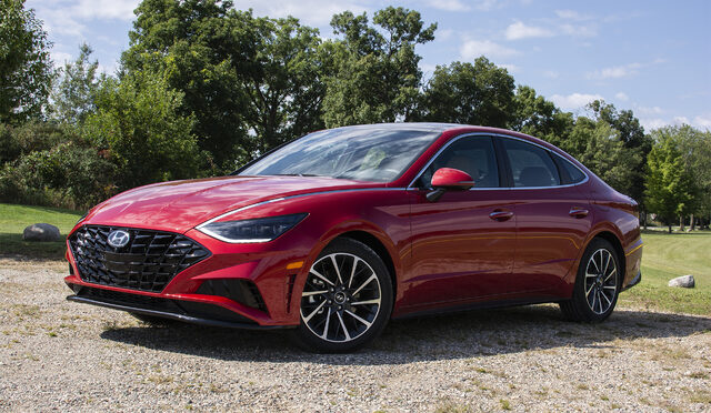 2020 Hyundai Sonata Limited 1.6T front three-quarter view in red at outdoor gravel setting