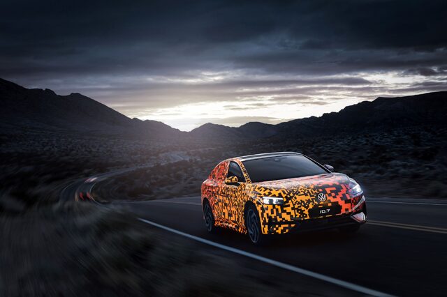 2024 Volkswagen ID.7 Concept driving at dusk with orange camouflage