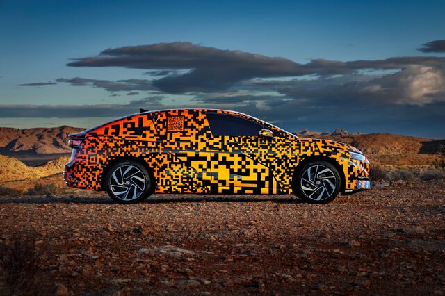 2024 Volkswagen ID.7 Concept side profile in desert with orange camouflage