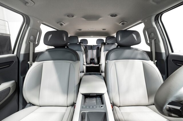 2024 Kia EV9 second-row seating view showing three-across bench with light and dark two-tone leather upholstery