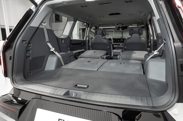 2024 Kia EV9 cargo area with second and third-row seats folded flat, showing the large flat-floor load space from the E-GMP platform