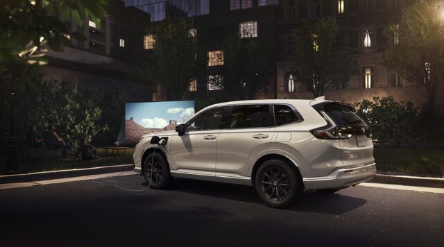 2025 Honda CR-V e:FCEV Plugged In at Night with Outdoor Screen