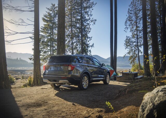 2025 Ford Explorer Platinum rear three-quarter view at a forest campsite
