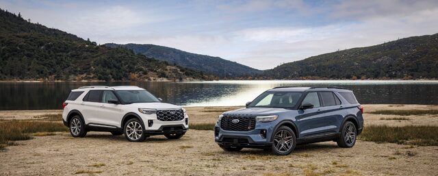 2025 Ford Explorer Platinum and ST side by side by a mountain lake