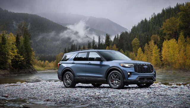 2025 Ford Explorer ST front three-quarter view in blue by a river