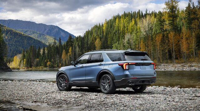 2025 Ford Explorer ST rear three-quarter view in blue by a mountain river