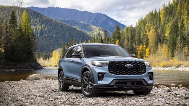 2025 Ford Explorer ST in blue front three-quarter view by a mountain river