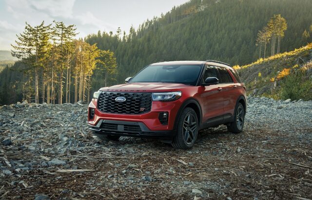2025 Ford Explorer ST in red front three-quarter view on a rocky hillside