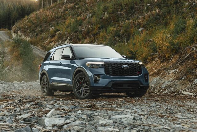 2025 Ford Explorer ST in blue low-angle front three-quarter view on rocks