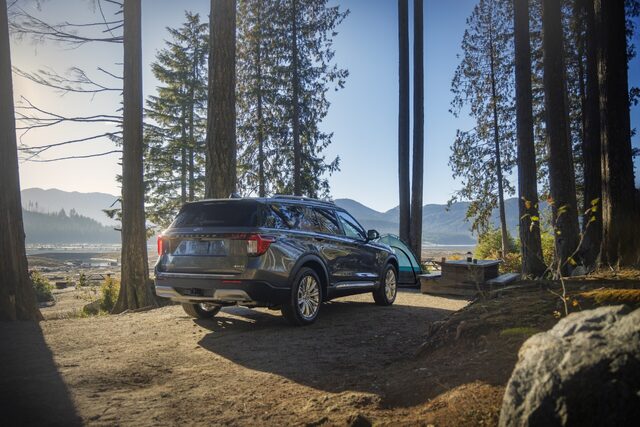 2025 Ford Explorer Platinum rear view at a lakeside campsite