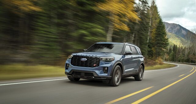 2025 Ford Explorer ST in blue driving on a curving mountain road