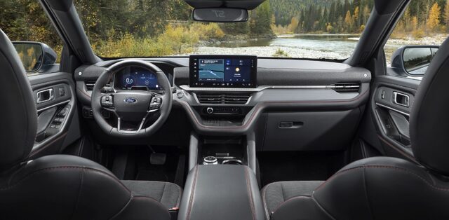 2025 Ford Explorer ST interior dashboard with dark leather and red stitching