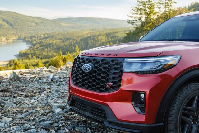 2025 Ford Explorer ST in red front grille and headlight detail on a rocky hillside