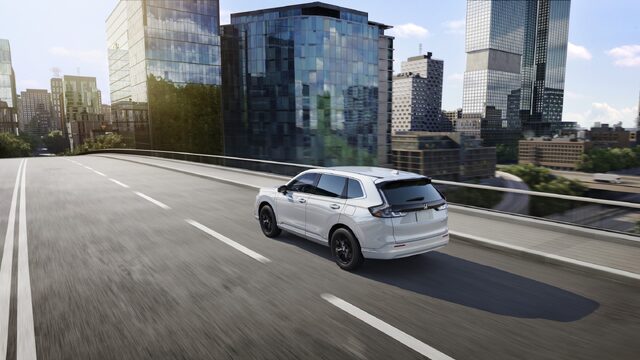 2025 Honda CR-V e:FCEV White Rear Three-Quarter Driving on Highway