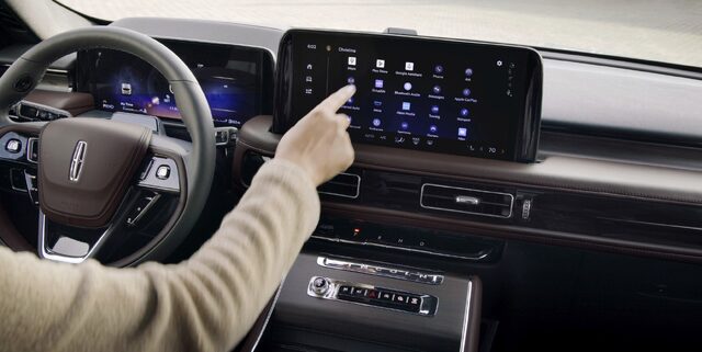 2025 Lincoln Aviator driver using touchscreen infotainment