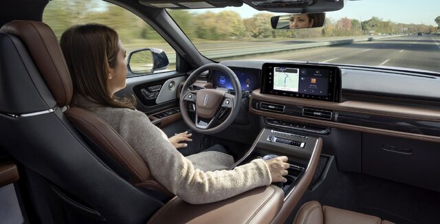 2025 Lincoln Aviator driver at wheel with navigation active