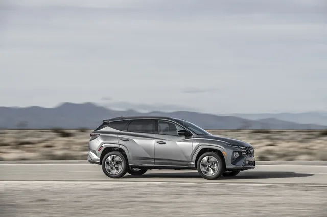 2025 Hyundai Tucson Passenger Side Profile Driving Shot in Silver