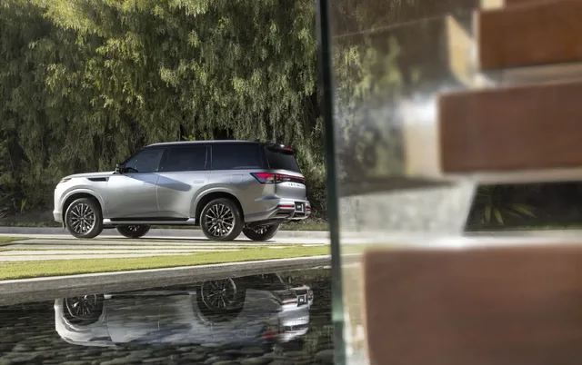 2025 Infiniti QX80 rear quarter view with water reflection